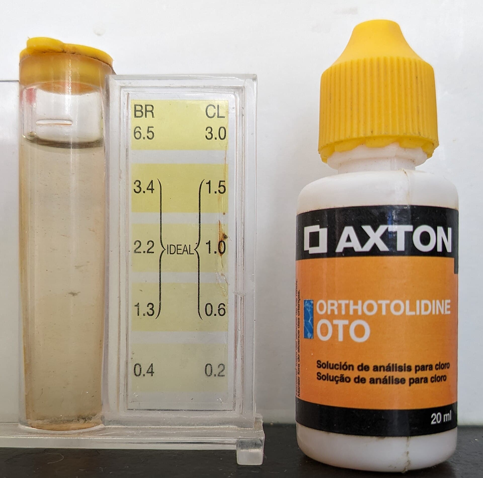 Liquid pool water test kit with sample vial, color comparator chart, and orthotolidine chlorine testing solution